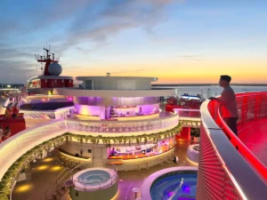 Virgin Voyages luxury cruise ship deck at sunset showcasing the adults-only atmosphere