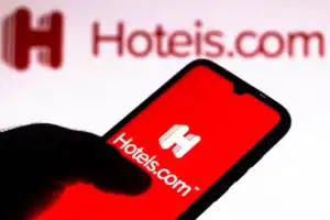 Mobile phone displaying Hotels.com app with coupon codes for discounts.
