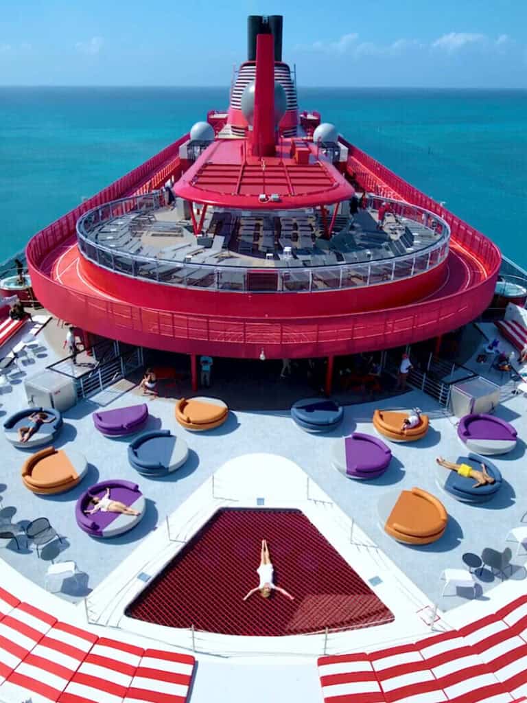Virgin Voyages Scarlet Lady cruise ship sailing at sunset – premium adults-only cruise experience.