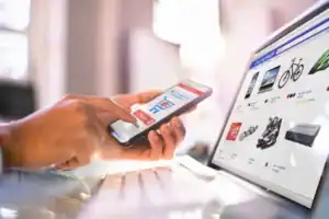 Person making an online payment using a mobile phone and credit card.