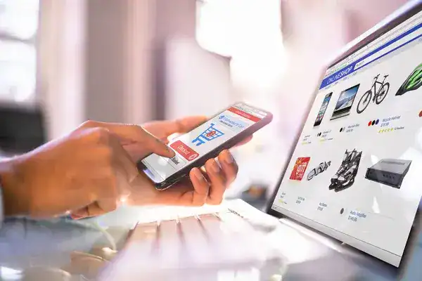Person making an online payment using a mobile phone and credit card.