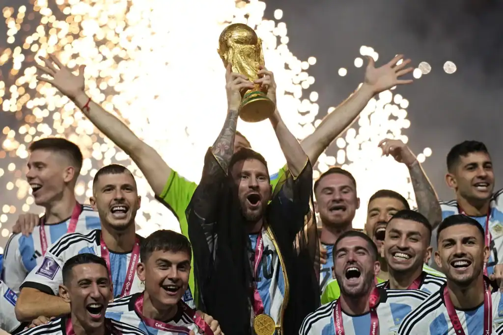 ionel Messi lifting the FIFA World Cup trophy with the Argentina national team, celebrating their victory amidst fireworks.