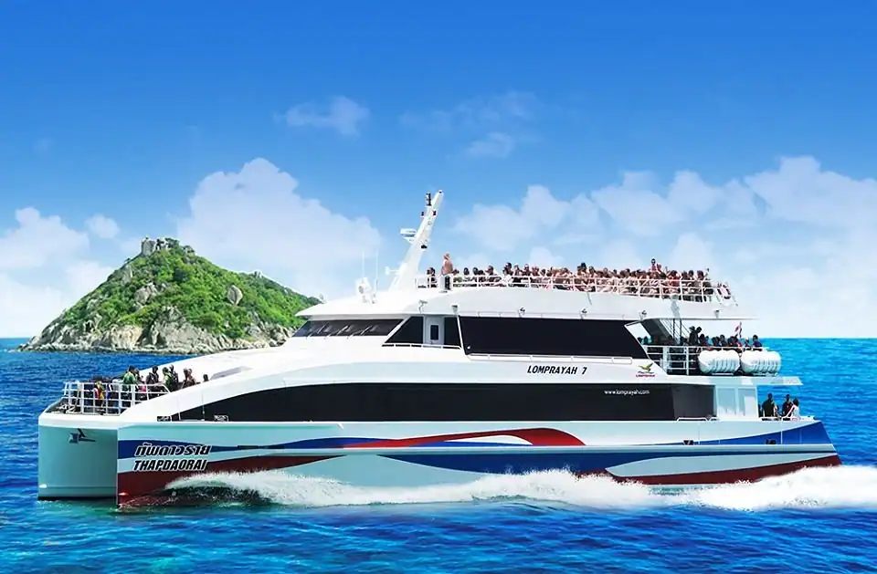 Passenger ferries at a tropical island port under a bright blue sky.