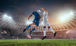 Professional soccer players heading the ball in a stadium match.