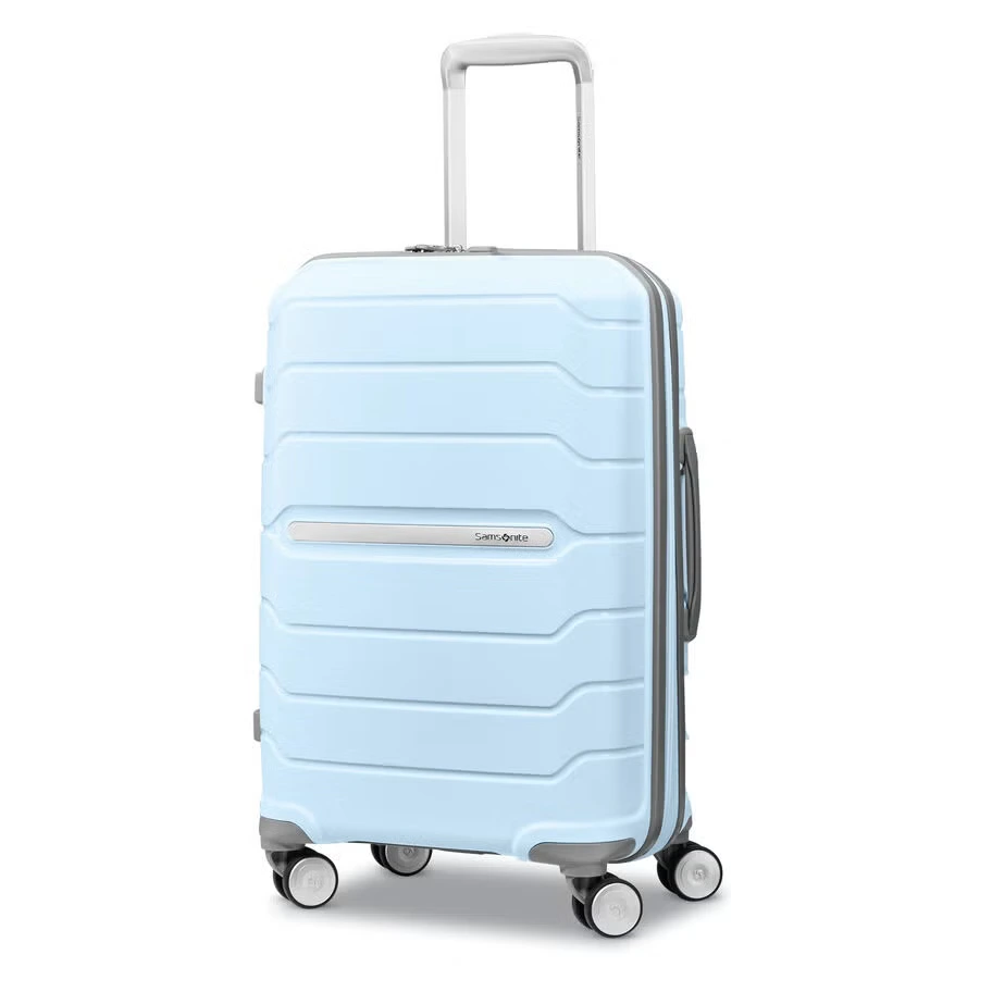 A close-up view of a light blue suitcase, highlighting its extendable metallic handle, top carry handle, and integrated combination lock.