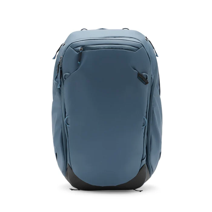 A minimalist blue travel backpack with black base detailing, designed for organization and outdoor adventure, shown against a white background.