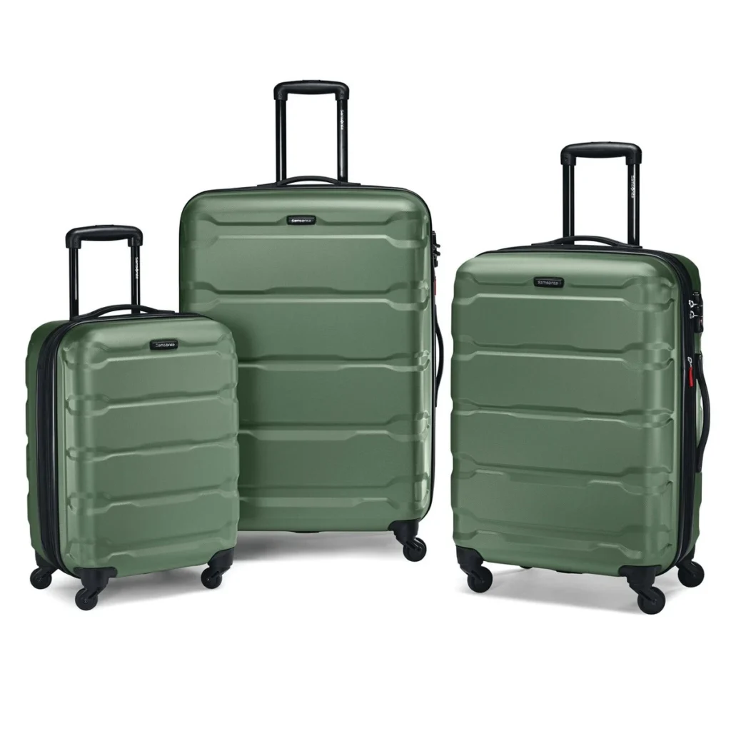 A close-up of a black TSA-approved combination lock secured on a textured green suitcase, showing the locking mechanism and zipper pulls.