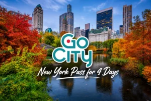 A scenic view of a park pond during autumn, framed by colorful fall foliage with the New York City skyline and the Go City 4-day pass logo.