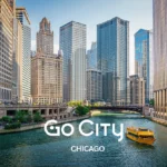 A yellow tour boat travels down the Chicago River, surrounded by the city's iconic skyscrapers with the Go City Chicago logo displayed.