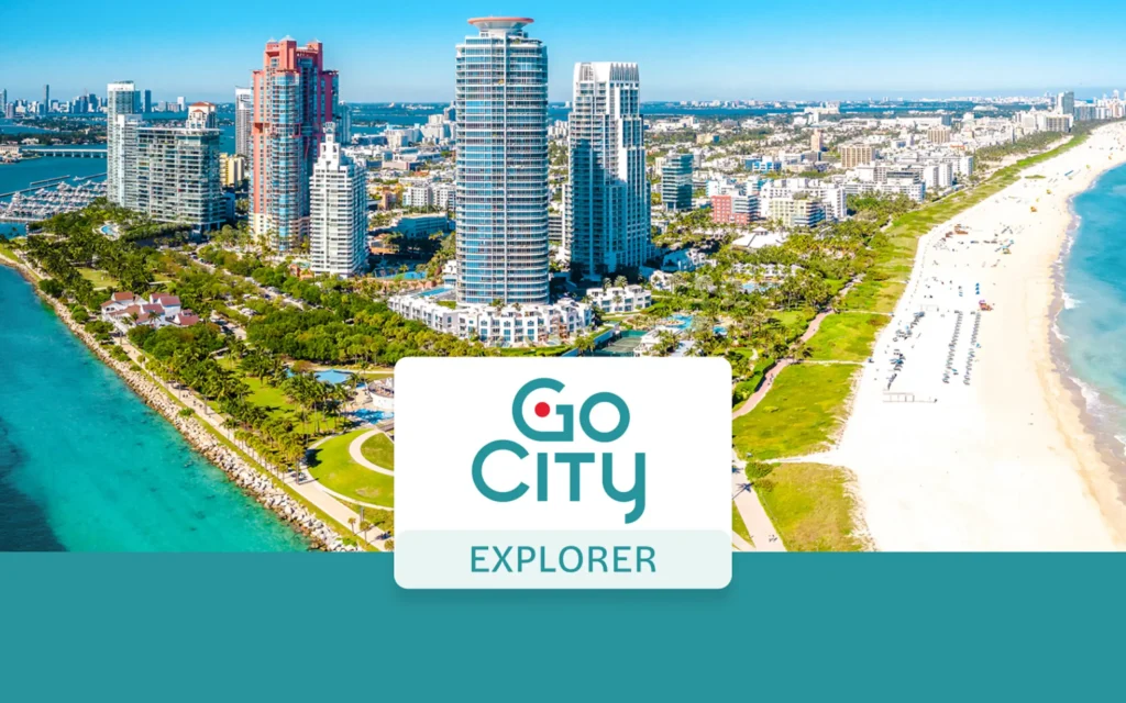 Aerial view of coastal skyscrapers and a sandy beach featuring the Go City Explorer logo in the foreground.