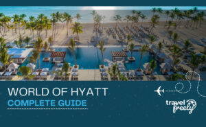 Banner for the World of Hyatt Complete Guide featuring an aerial view of a luxury tropical resort with a pool and beach